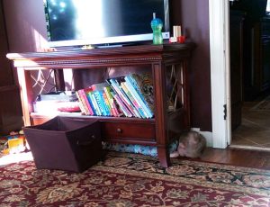 boy under furniture playing hide and seek